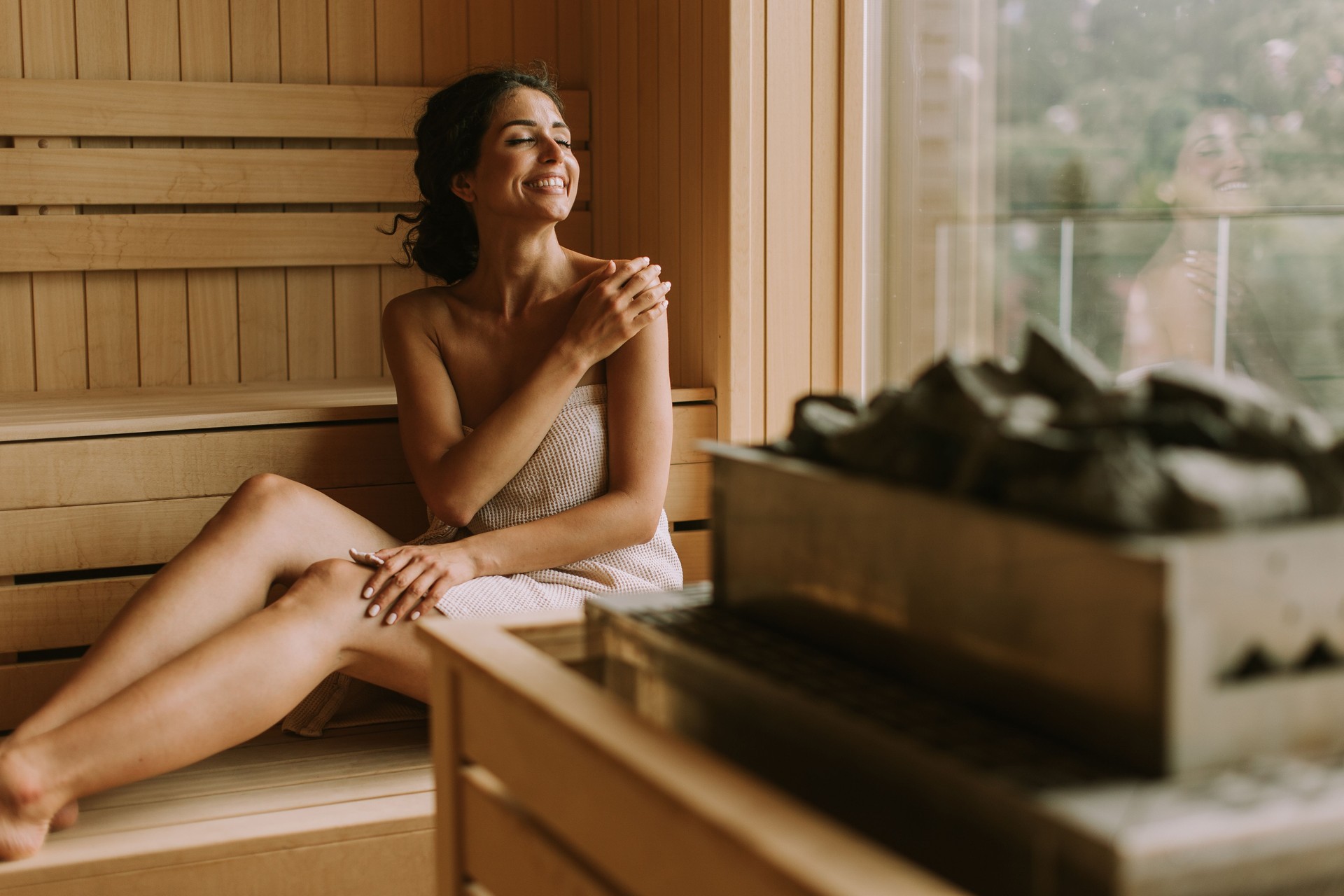 Young woman relaxing in the sauna